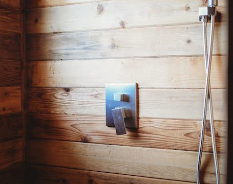 Enjoy a warm shower in this rustic wood-paneled bathroom—perfect for relaxing after Alaska adventures or wedding celebrations.