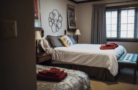 Cozy lodge bedroom in Fairbanks Alaska with elegant decor and natural light, ideal for weddings or unique stays