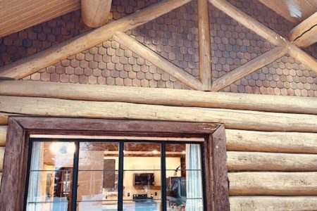 Close-up of log cabin wall and window with wood detailing in Fairbanks Alaska lodge or rental