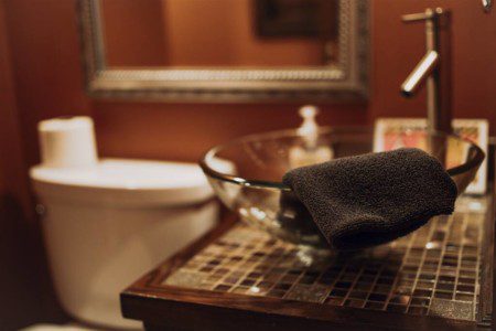 Modern rustic bathroom with glass vessel sink and mosaic countertop in a Fairbanks Alaska adventure lodge