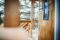 Wooden staircase and landing leading up to a treehouse rental in Fairbanks Alaska