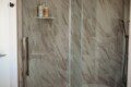 Treehouse bathroom with marble walk-in shower and black fixtures in Fairbanks, Alaska