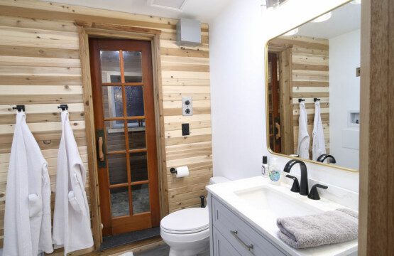 Rustic wood-accented bathroom with white vanity and natural light in Fairbanks Alaska