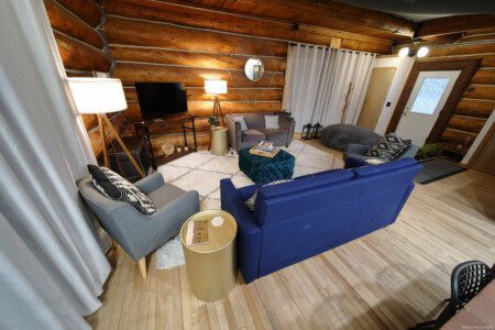 Rustic log cabin living room with modern furniture and soft lighting in Fairbanks Alaska