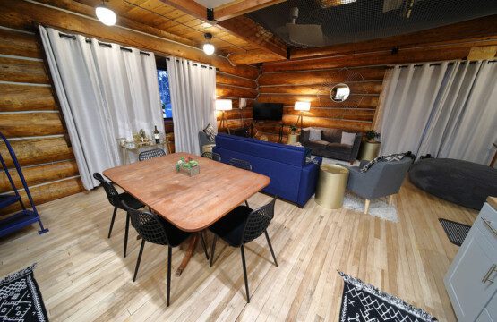 Rustic log cabin living room with modern furniture and soft lighting in Fairbanks Alaska
