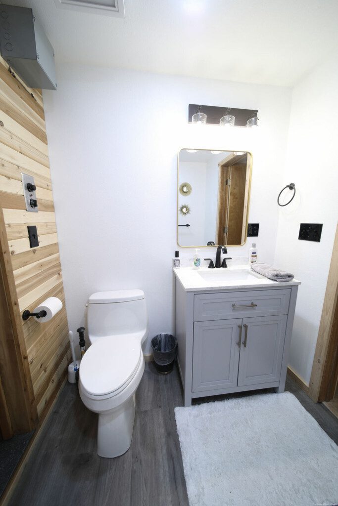 Rustic wood-accented bathroom with white vanity and natural light in Fairbanks Alaska
