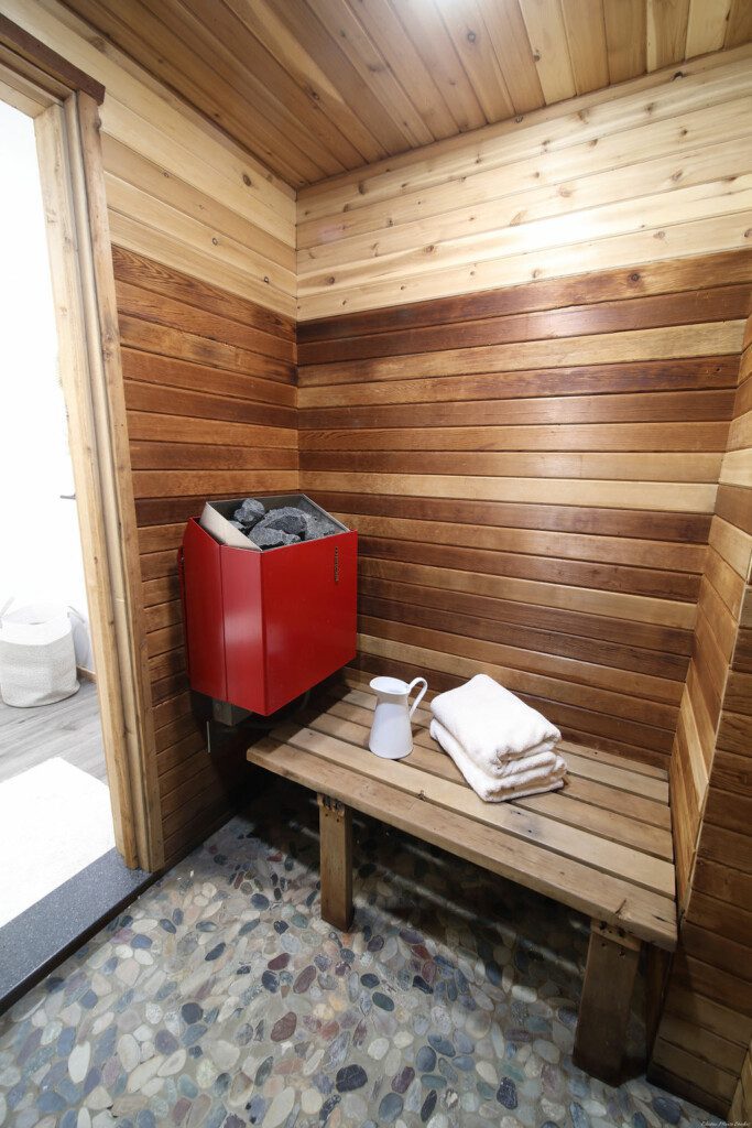 Rustic wood-accented bathroom with white vanity and natural light in Fairbanks Alaska