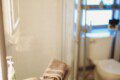 Modern bathroom with mirror and sink inside restored railcar lodge in Fairbanks.