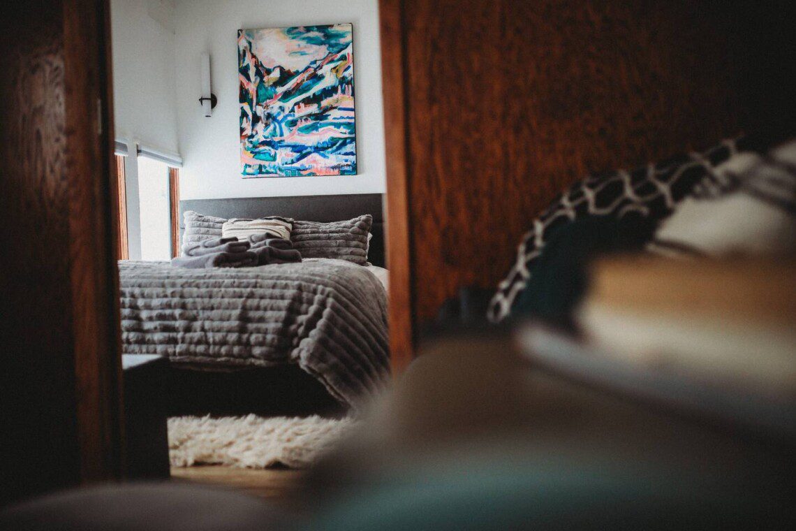 Bedroom and seating area inside restored Alaska railroad lodge in Fairbanks.