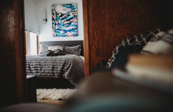 Bedroom and seating area inside restored Alaska railroad lodge in Fairbanks.