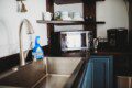Modern kitchen inside restored railcar at Alaska adventure lodge in Fairbanks.