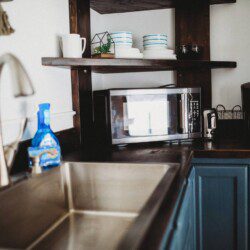 Modern kitchen inside restored railcar at Alaska adventure lodge in Fairbanks.
