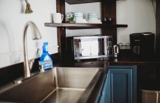 Modern kitchen inside restored railcar at Alaska adventure lodge in Fairbanks.