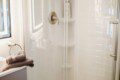 Modern bathroom with mirror and sink inside restored railcar lodge in Fairbanks.