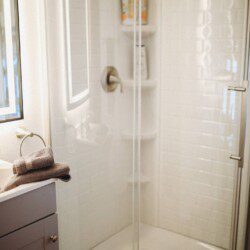 Modern bathroom with mirror and sink inside restored railcar lodge in Fairbanks.