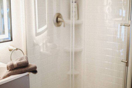 Modern bathroom with mirror and sink inside restored railcar lodge in Fairbanks.