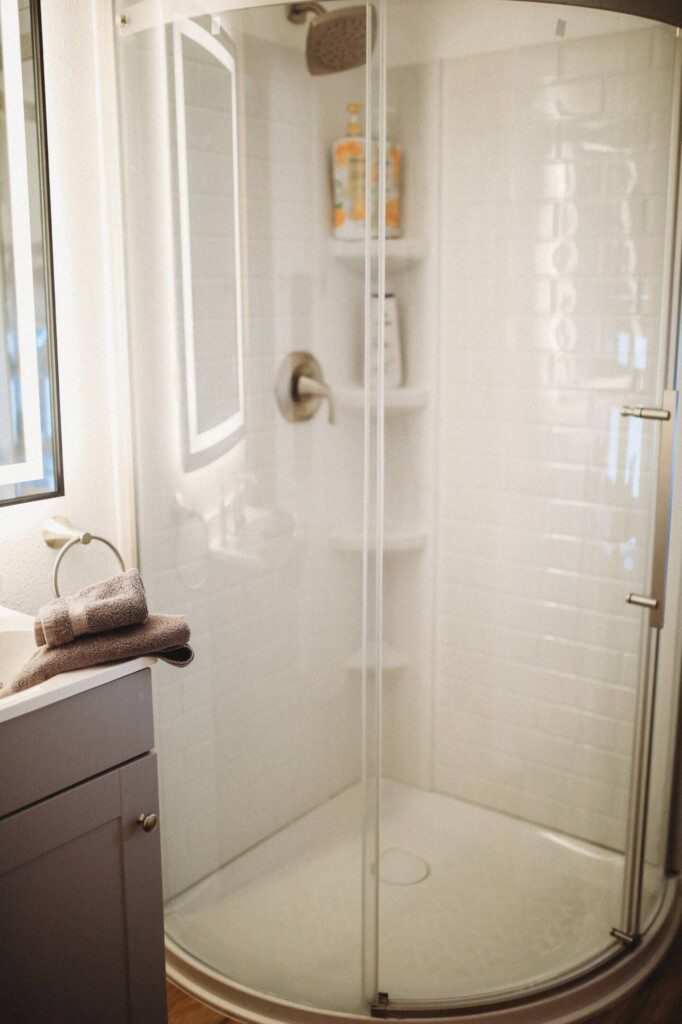 Modern bathroom with mirror and sink inside restored railcar lodge in Fairbanks.