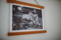 Framed historic Fairbanks prints on white wall in vintage railcar lodge.