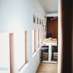 Dining area with windows inside restored railcar lodge in Fairbanks, Alaska.