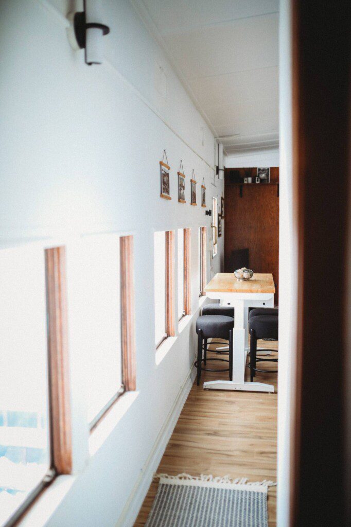 Dining area with windows inside restored railcar lodge in Fairbanks, Alaska.