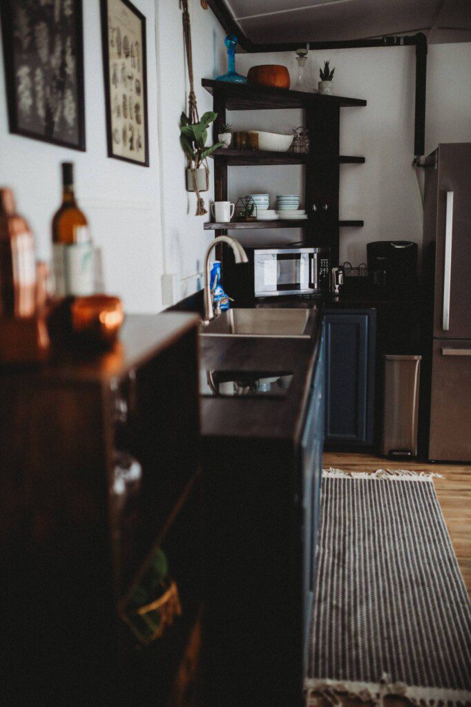 Modern kitchen inside restored railcar at Alaska adventure lodge in Fairbanks.