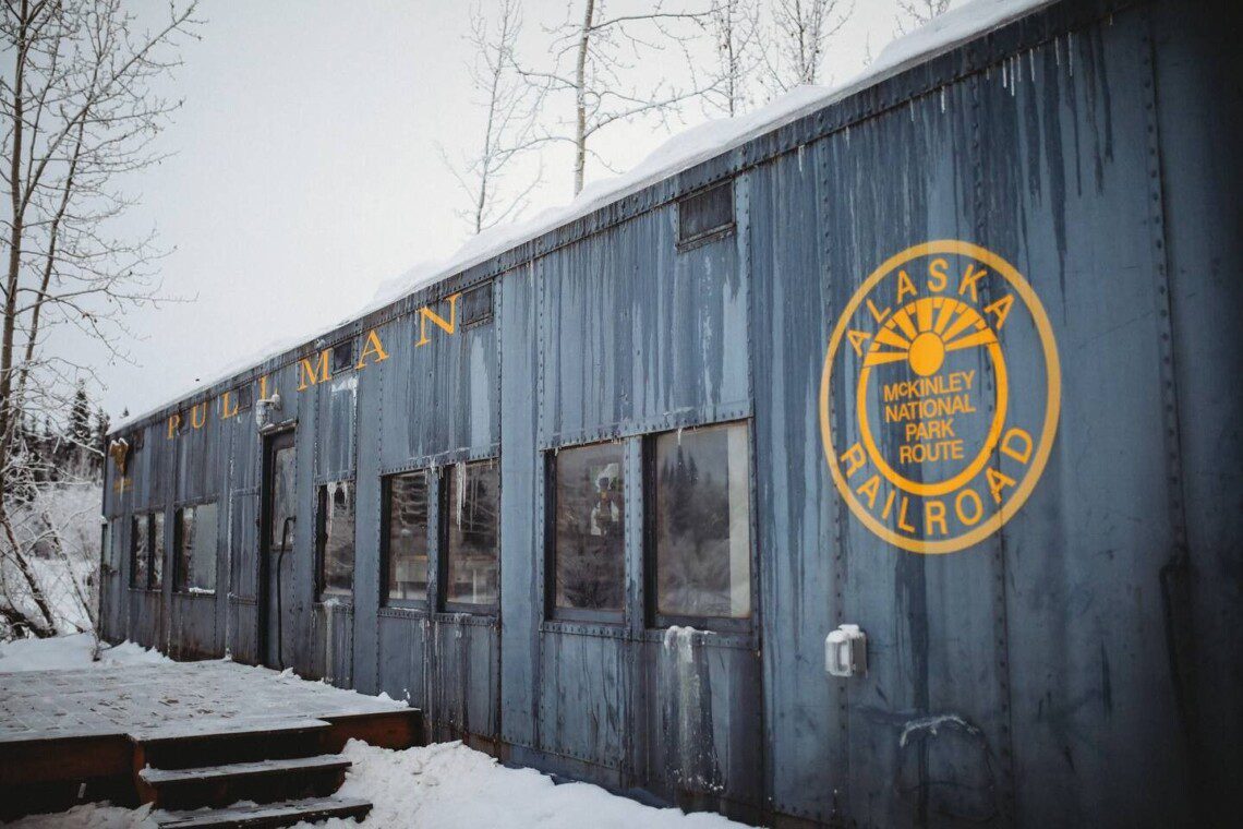 Snow-covered Alaska Railroad car lodge stay in Fairbanks adventure setting.