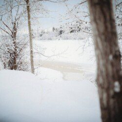 Historic railcar lodging with snowy deck and winter trees in Fairbanks Alaska