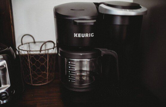 Keurig coffee maker with glass carafe on a wooden counter in a Fairbanks Alaska lodge rental