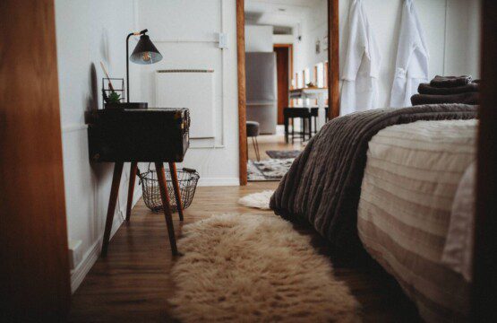 Comfortable bed with folded towels inside Alaska railroad car lodge in Fairbanks.