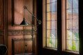 Spacious lodge interior with high ceilings, chandeliers, and large windows in a Fairbanks adventure lodge