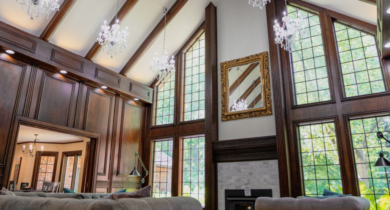 Spacious lodge interior with high ceilings, chandeliers, and large windows in a Fairbanks adventure lodge