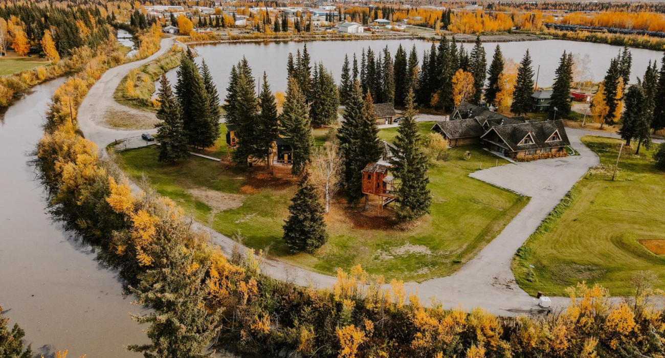 Alaska adventure lodge with treehouse rentals in Fairbanks — a unique place to stay and top wedding venue by the river.